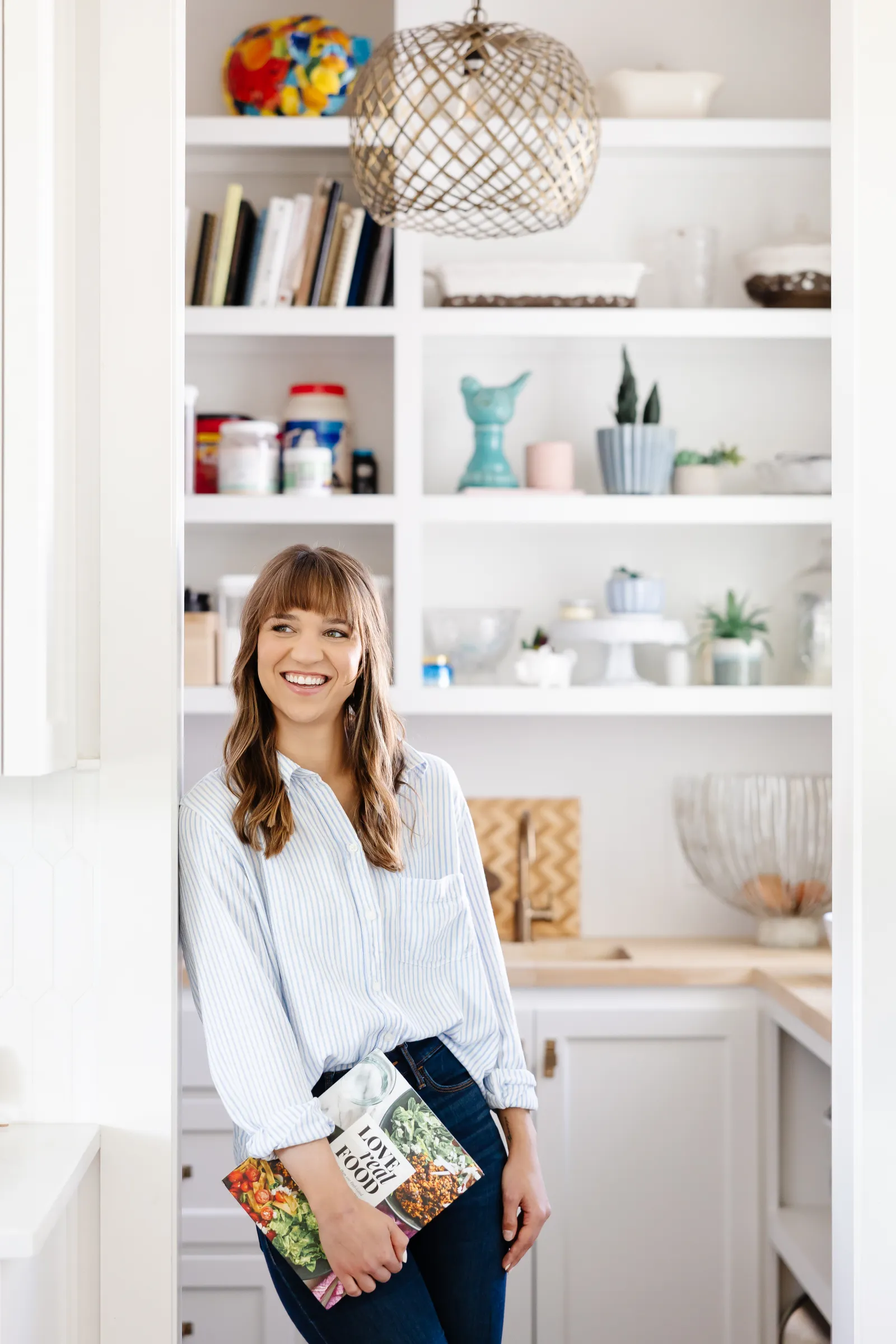 Alicia in the kitchen with a cookbook
